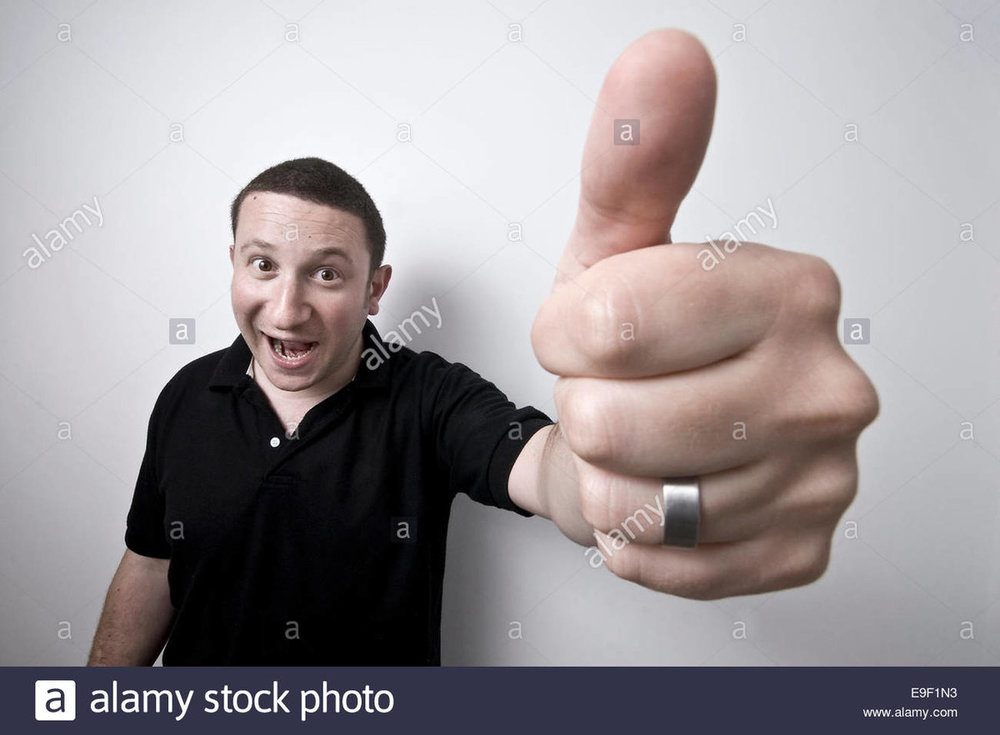 a-man-gives-a-giant-thumbs-up-to-the-camera-E9F1N3.jpg